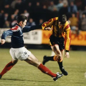 Falkirk footballer David Weir moving in to cut out the threat of Gerry Britton during