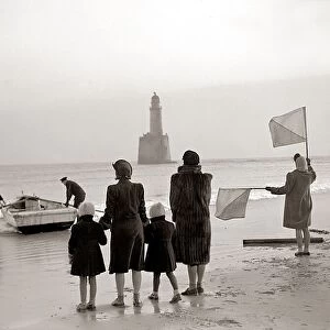 The families of the Rattray Head lighthouse keepers semaphore their loved ones as Old