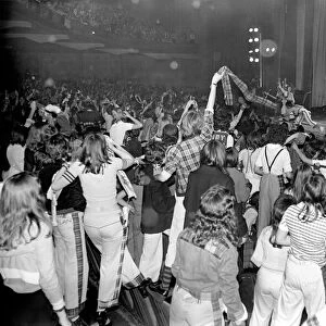 Fans cheer as the Bay City Rollers perform on stage at Cardiff. May 1975