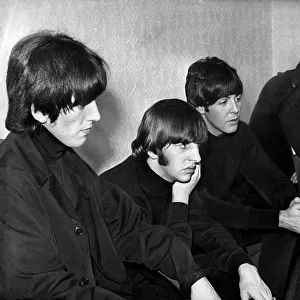 While the fans scream, the Beatles sit calmly backstage - watching themselves