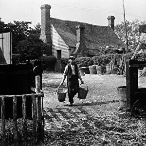 Farmer walks towards the hen house at Chapel Church Farm, Kent
