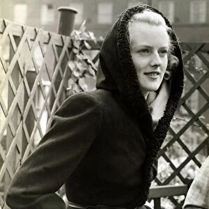 Fashion 1930s Model Waring a black wool coat with hood
