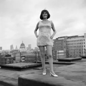 Fashion Clothing. Sue Sampson model girl, 24, in a dress made from poultry feathers in