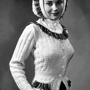 Fashion December 1950 Model from 1950s wearing a fitted cream cardigan with detail