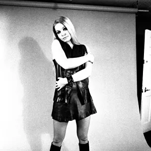 A fashion shoot from 13 April 1970 - A model wears a dress with knee lenght boots