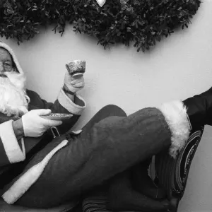 Father Christmas with a cup of tea in his grotto Birmingham. 23rd December 1988 Father Christmas with a cup of tea in his grotto Birmingham. 23rd December 1988