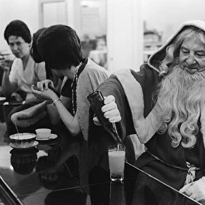 Father Christmas having a drink in a cafe bar in Paris