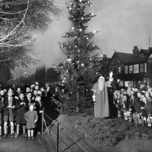 Father Christmas leads school children in carol singing around the Council Father Christmas leads school children in carol singing around the Council