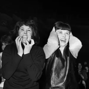 Two female fans watching The Beatles play at Manchester. 20th November 1963