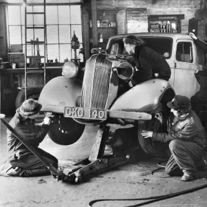 Female ARP mechanics repairing a car with number plate CKD 140, Print Female ARP mechanics repairing a car with number plate CKD 140, Print