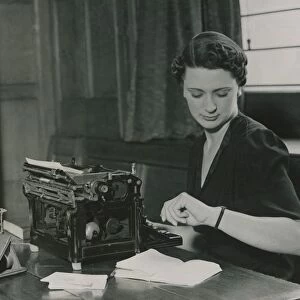 Female office worker checking her watch June 1937