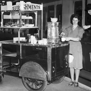 A female worker at Snow Hill Railway station in Birmingham serves a cup of tea from her