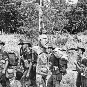 Print of a soldier examining a hanging idol in Aitape Sector, New Guinea Print of a soldier examining a hanging idol in Aitape Sector, New Guinea