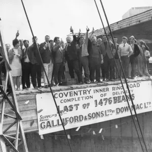 Fifty men with a bottle of beer each to celebrate the lowering into position of the last Fifty men with a bottle of beer each to celebrate the lowering into position of the last
