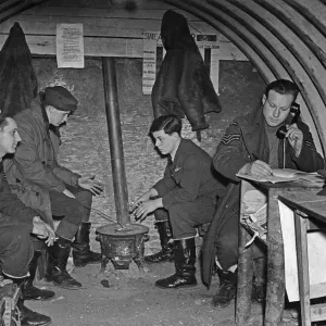 Print of RAF Fighter Pilots by a brazier in their underground office