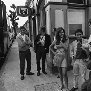 Film Bedazzled 1967 Raquel Welch Dudley Moore and Peter Cook standing outside pub