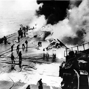 Fire crews battle to put out fire on the aircraft carrier US Saratoga after being hit