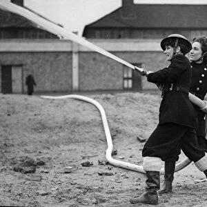 Fire women of the National Fire Service using a hose during training exercises inn