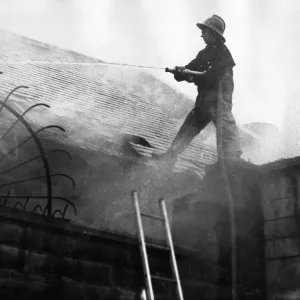 Firefighters clambered over the roofs high above the city to tackle a blaze that Firefighters clambered over the roofs high above the city to tackle a blaze that