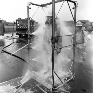 Firefighters are decontaminated after dealing with the chemical spillage at the scene Firefighters are decontaminated after dealing with the chemical spillage at the scene