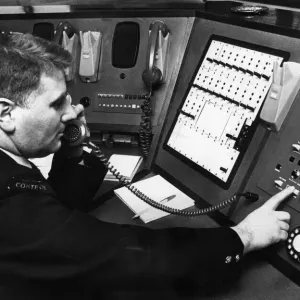 Fireman demonstrates new electronic private circuit system installed in Control Room