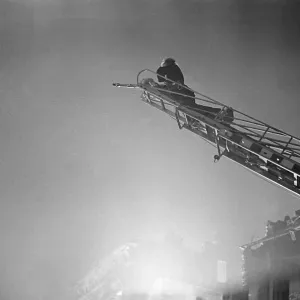Fireman tackle a blaze in the Waterloo area cause by High Explosive bombs during the 2nd