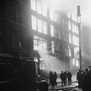 Firemen attempt to control a fire in Shoreditch, London