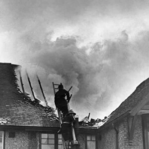 Firemen attend to a roaring blaze at a house on Tilehurst Road