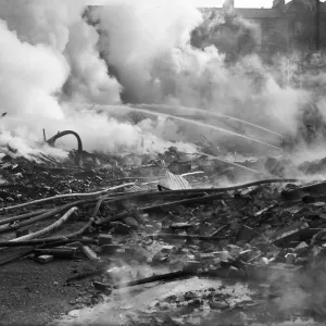 Firemen dampen down the fires caused by a a Luftwaffe attack on the City of Bristol Firemen dampen down the fires caused by a a Luftwaffe attack on the City of Bristol