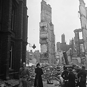 Firemen dampening down the smouldering ruins in the the City of London following