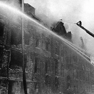 Firemen fight a fire in Camberwell New Road London after a German flying bomb attack