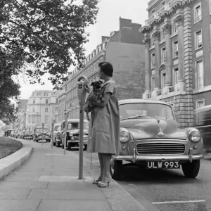 Print of a lady paying parking fee in Grosvenor Square, London, 10th July 1958 Print of a lady paying parking fee in Grosvenor Square, London, 10th July 1958