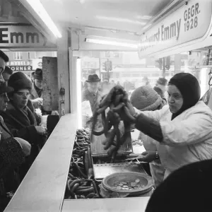 Print of people queuing for Bockwurst in East Berlin, December 1963