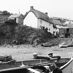 Fisherman launch one of the small fishing boats at Cadgwith. July 1939