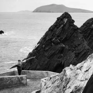 a fisherman makes his way down to the harbour on Ireland a fisherman makes his way down to the harbour on Ireland