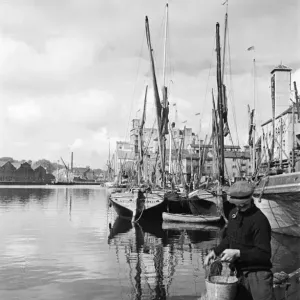 Fisherman at the quayside at Ipswich Docks, on the estuary of the River Orwell, Suffolk