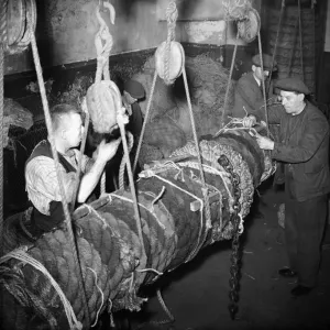 Fishermen seen here making a new fender for the fishing fleet moored in the Cornish Fishermen seen here making a new fender for the fishing fleet moored in the Cornish