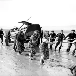 Fisherwomen of New Biggin, England hauling their boat ashore Women fulfilling Mens Fisherwomen of New Biggin, England hauling their boat ashore Women fulfilling Mens