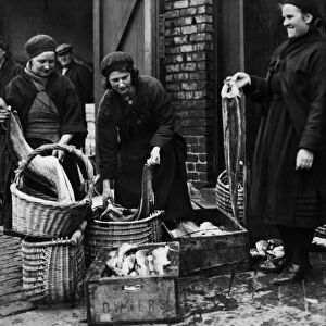 Fishwives of Cullercoats filling their creels for the days rounds at North Shields Fish