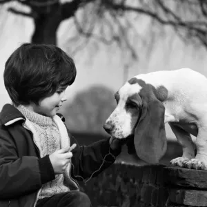 Five-year-old Caroline Williams of Northwood Hills with five-month-old Basset Hound puppy Five-year-old Caroline Williams of Northwood Hills with five-month-old Basset Hound puppy
