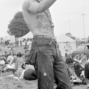 Flower Power festival at Woburn Abbey, August 1967 A hippy dressed with feathers in Flower Power festival at Woburn Abbey, August 1967 A hippy dressed with feathers in