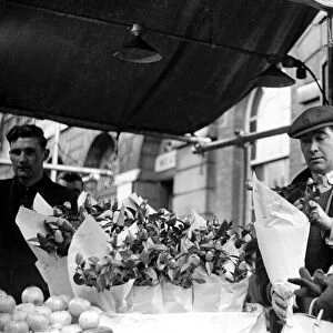 The flower seller at Kingston market seen here serving a customer. Circa 1936