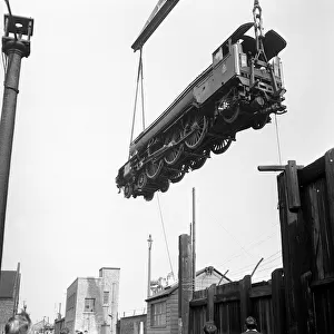 The Flying Scotsman steam train being loaded on board the Saxonia by the floating crane