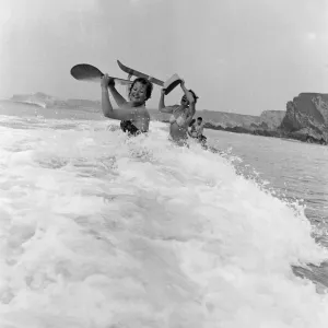 When the foaming waves break with a roar, bathers throw themselves forward onto their When the foaming waves break with a roar, bathers throw themselves forward onto their