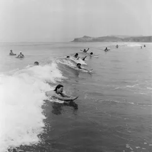 When the foaming waves break with a roar, bathers throw themselves forward onto their When the foaming waves break with a roar, bathers throw themselves forward onto their