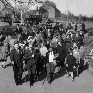 Followed by local children the tutti-men set out to pay their calls for a coin or a kiss
