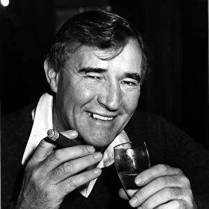 Football manager Malcolm Allison with a cigar and a glass of wine. Circa 1975