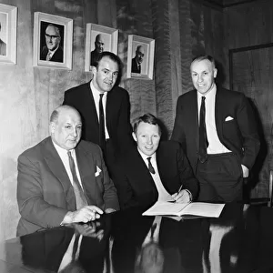 Footballer Dave Wilson signs for Liverpool Football Club at Anfield for £