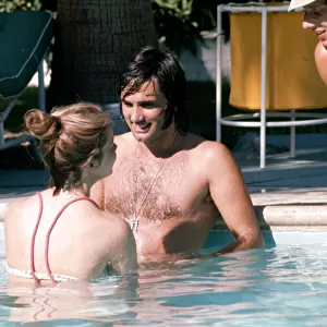 Footballer George Best relaxes with girlfriend Linda Joinett in a swimming pool in Palm