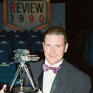 Footballer Paul Gascoigne smiles as he holds the Sports Personality of The Year award